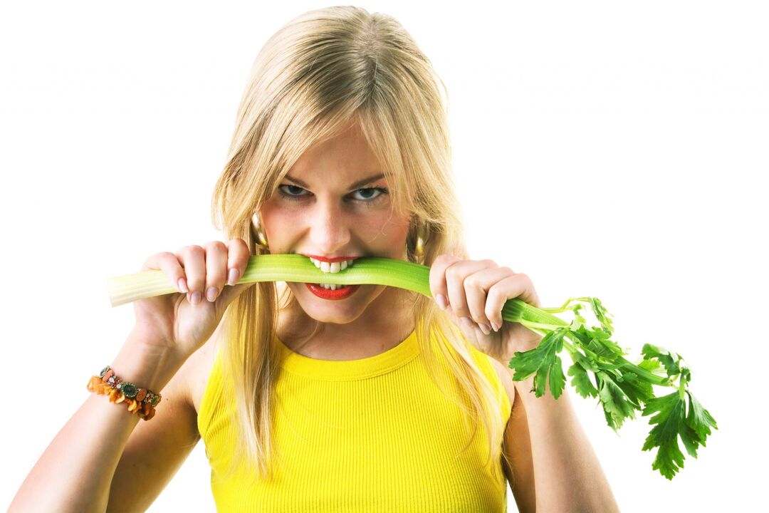 The girl eats celery for weight loss